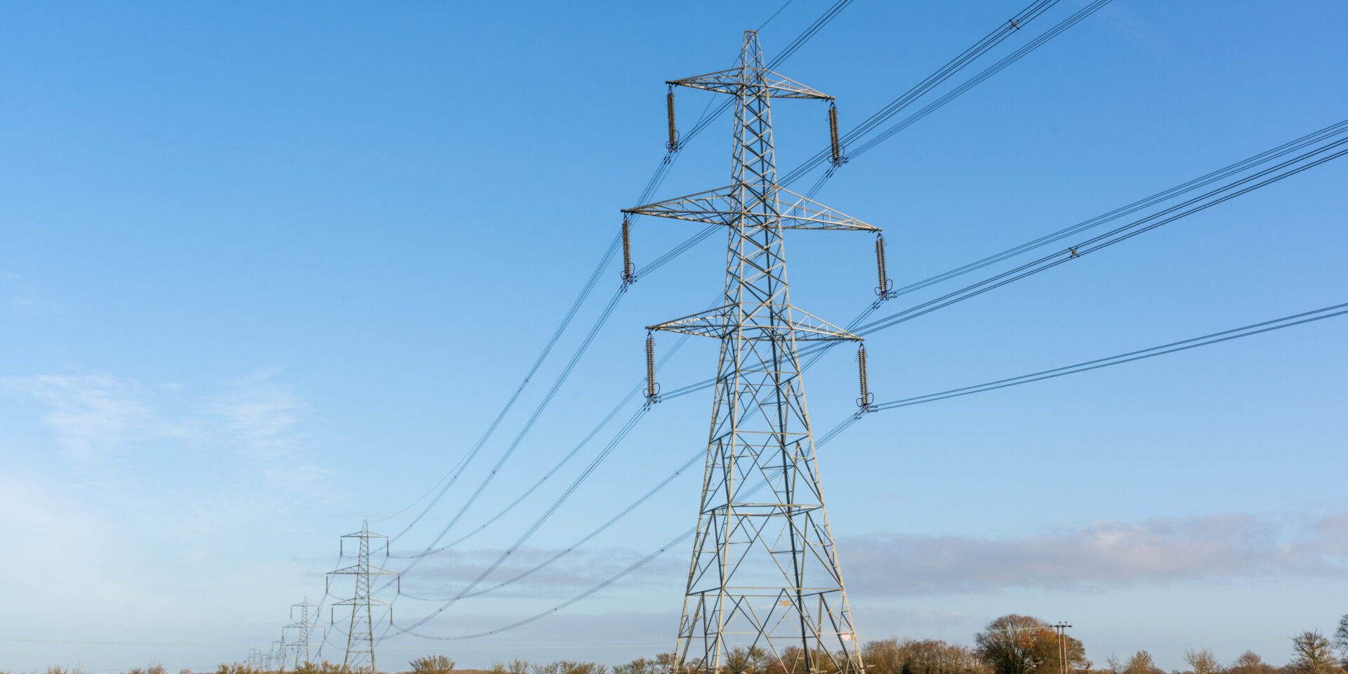 Electricity pylons in a field with blue sky. Bishop’s Stortford,